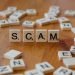 Scam spelled with word blocks.