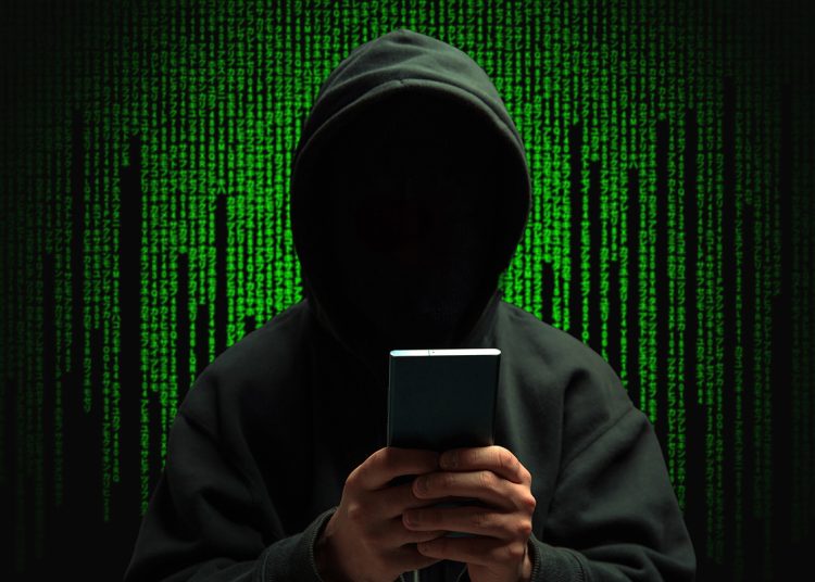computer hacker surrounded by computer code