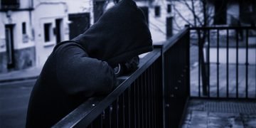 young man with head covered in street gang